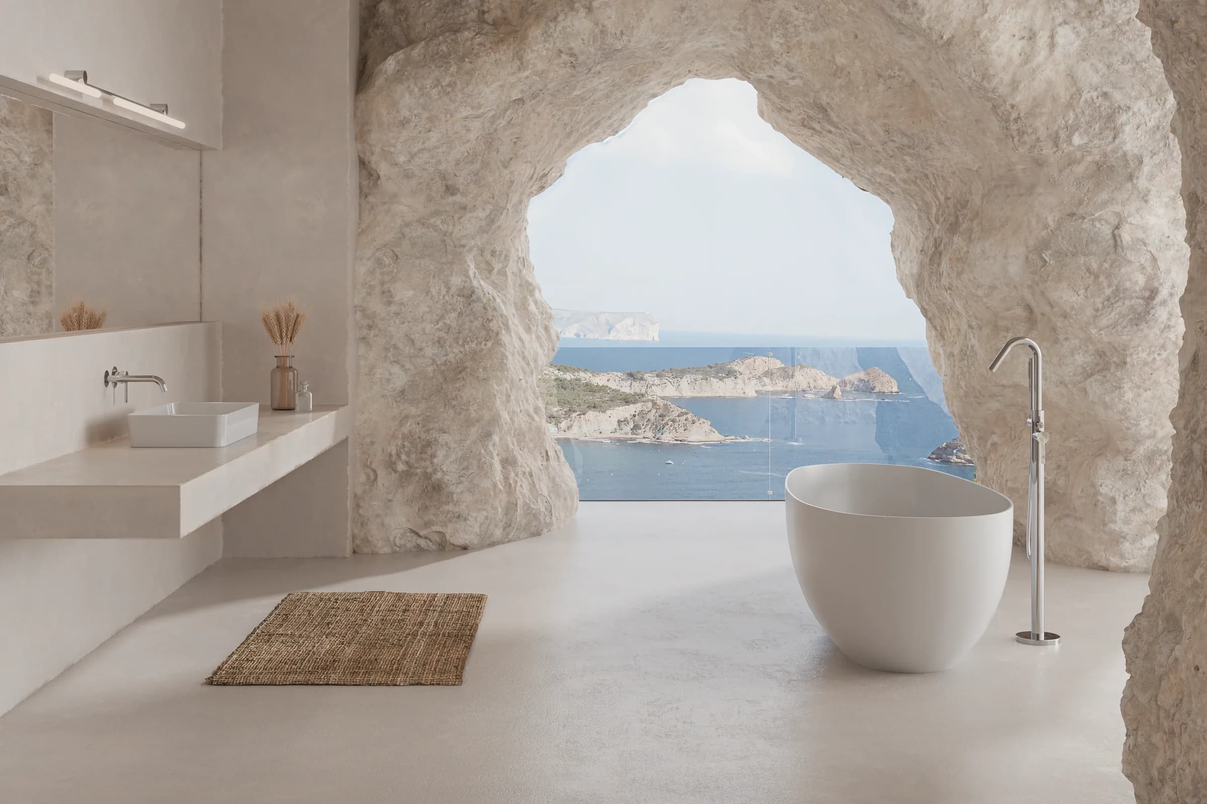 Suite d'hotel amb banyera exempta i aixeteria de peu ramonsoler, excavada a la roca davant del mar